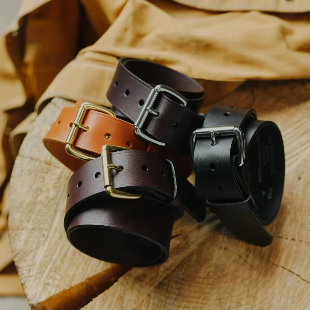 Leather belts coiled on tan canvas