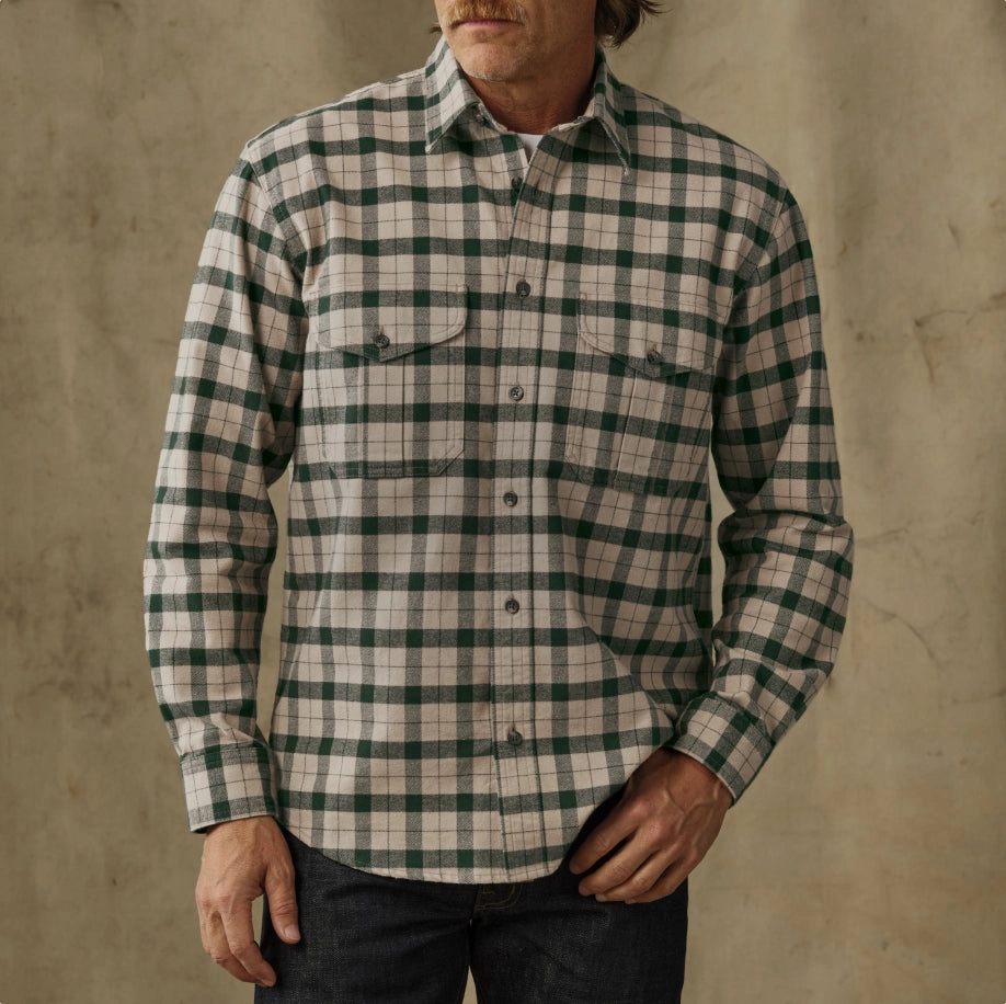 Man in a cream and green plaid flannel shirt