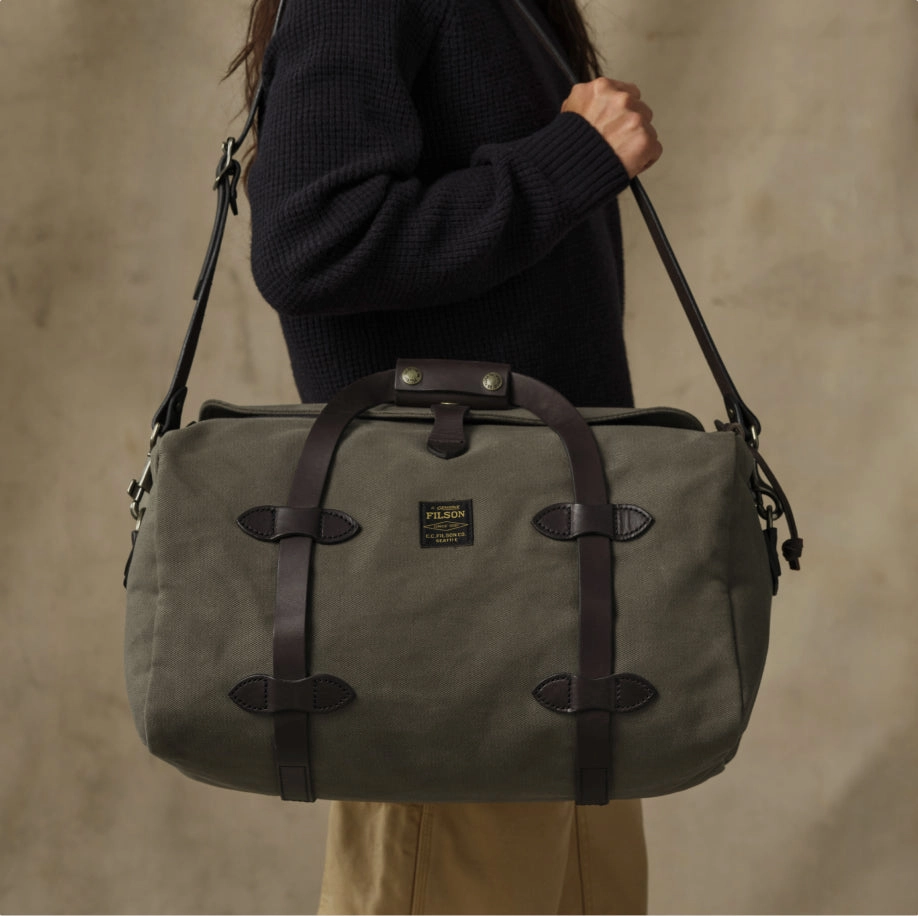 Olive duffle bag on a shoulder strap