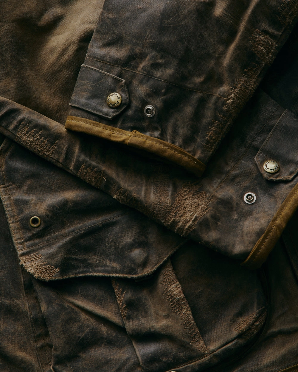 Close-up of a worn brown leather cuff with stitching