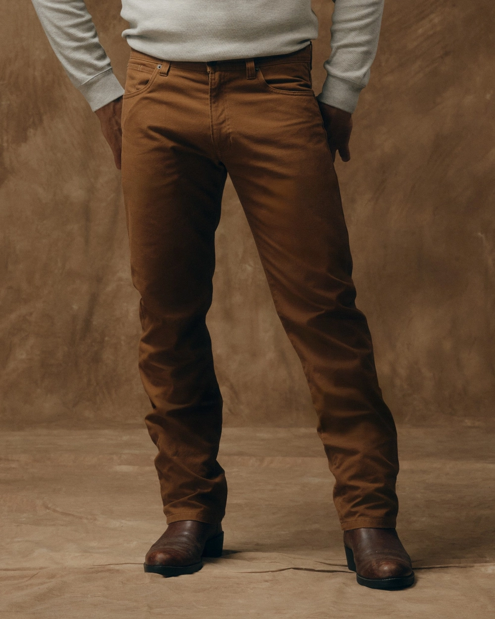Man in brown whiskey-colored five-pocket pants