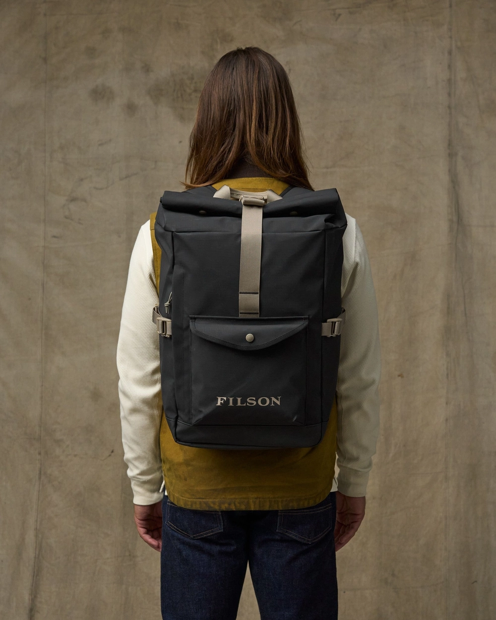 Person seen from behind wearing a black backpack